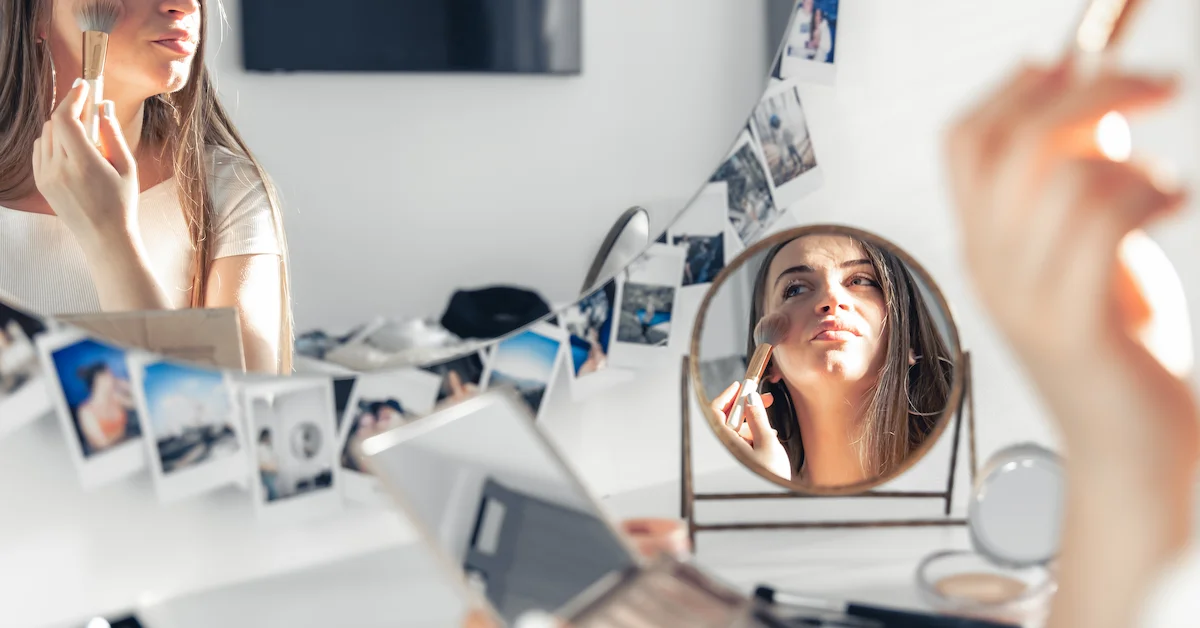 Bride applying makeup in natural morning light preparing for Pretoria wedding